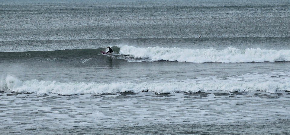 Surfer on a wave in front of the shop